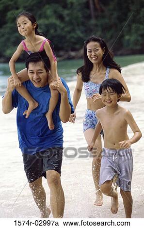 Parents with their son and daughter on the beach View Large Photo Image Stock Image - Parents with their son and daughter on the beach. Fotosearch