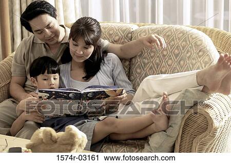 Parents with their son reading a book View Large Photo Image Stock Image - Parents with their son reading a book. Fotosearch