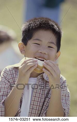 Portrait of a boy biting into a sandwich View Large Photo Image Stock Image - Portrait of a boy biting into a sandwich. Fotosearch