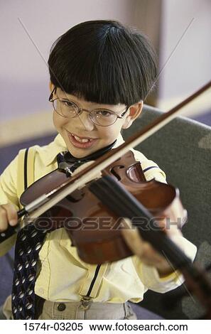 Portrait of a boy playing a violin View Large Photo Image Stock Photography - Portrait of a boy playing a violin. Fotosearch