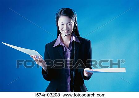 Portrait of a businesswoman holding sheets of paper View Large Photo Image Stock Photo - Portrait of a businesswoman holding sheets of paper. Fotosearch