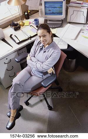 Stock Photograph - Portrait of a businesswoman in an office. Fotosearch