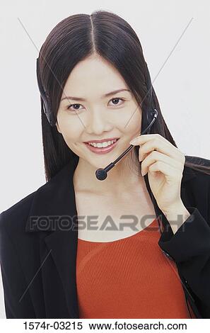 Portrait of a businesswoman wearing a headset smiling View Large Photo Image Stock Photography - Portrait of a businesswoman wearing a headset smiling. Fotosearch