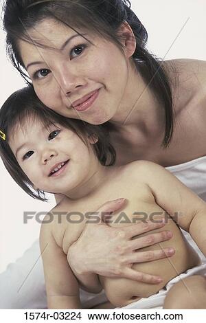 Picture - Portrait of a mother holding her baby girl. Fotosearch