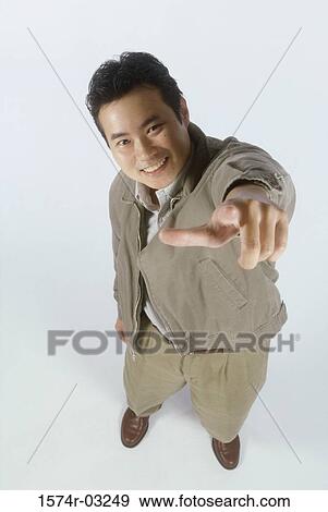 Stock Photo - Portrait of a young man pointing forward. Fotosearch