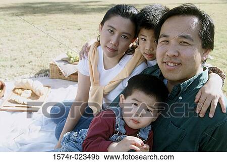 Stock Image - Portrait of parents with their children at a picnic. Fotosearch