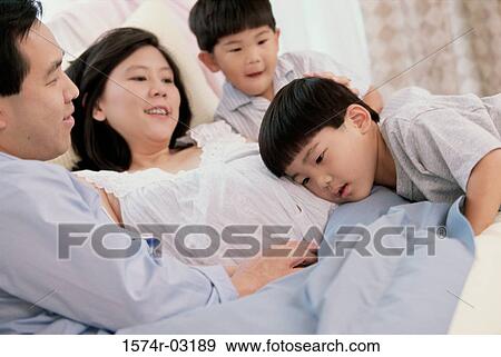 Son with his head against his pregnant mother's abdomen View Large Photo Image Stock Photo - Son with his head against his pregnant mother's abdomen. Fotosearch