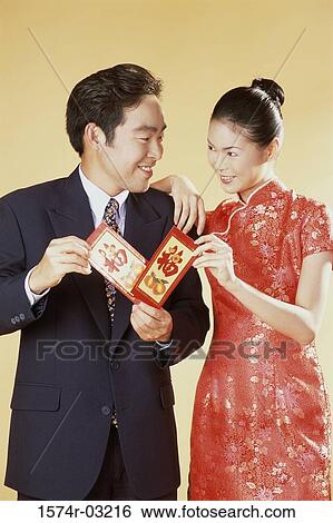 Young couple looking at each other and smiling View Large Photo Image Stock Photograph - Young couple looking at each other and smiling. Fotosearch