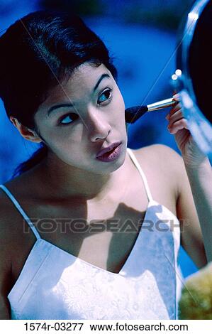 Young woman applying make-up View Large Photo Image Stock Photo - Young woman applying make-up. Fotosearch