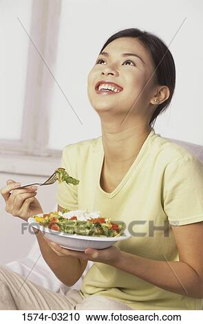 Young woman holding a bowl of salad View Large Photo Image Stock Image - Young woman holding a bowl of salad. Fotosearch