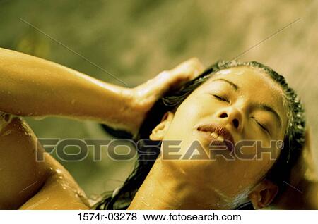 Stock Photo - Young woman taking a shower. Fotosearch