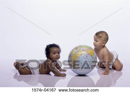 Baby boy and a baby girl playing with a globe View Large Photo Image Stock Photo - Baby boy and a baby girl playing with a globe. Fotosearch