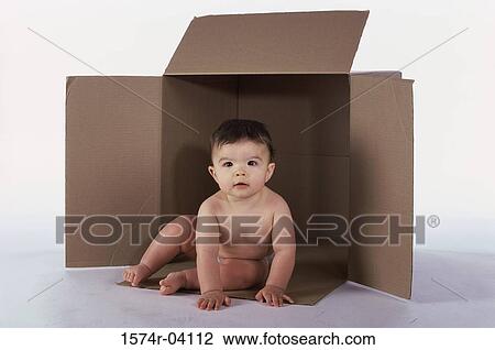 Baby boy sitting in an empty cardboard box View Large Photo Image Stock Image - Baby boy sitting in an empty cardboard box. Fotosearch