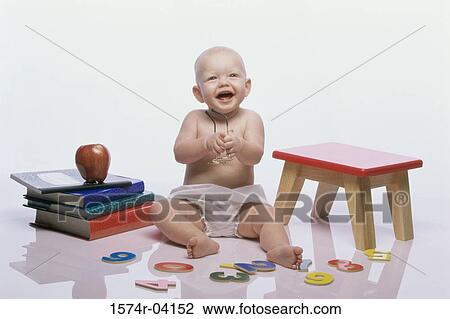 Baby boy sitting on the floor holding eyeglasses View Large Photo Image Stock Image - Baby boy sitting on the floor holding eyeglasses. Fotosearch