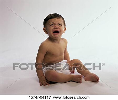 Stock Photo - Baby boy sitting up and crying. Fotosearch