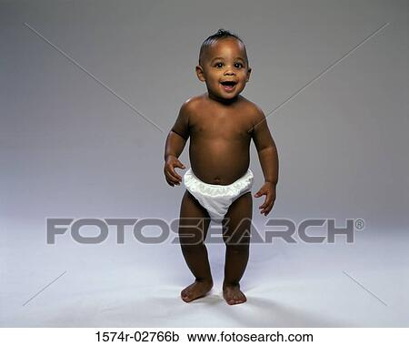 Stock Image - Baby boy trying to walk. Fotosearch