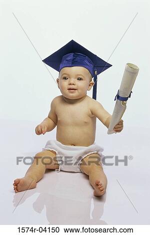 Stock Image - Baby boy wearing a mortar board holding a diploma. Fotosearch