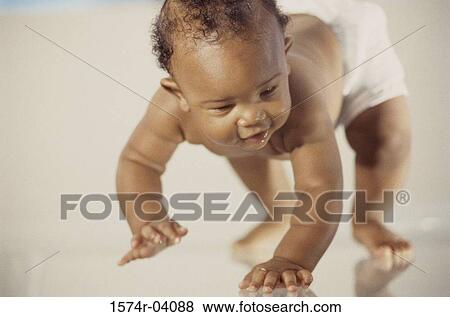 Close-up of a baby boy crawling View Large Photo Image Stock Photo - Close-up of a baby boy crawling. Fotosearch