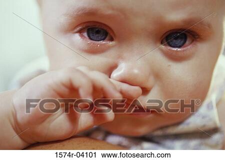 Close-up of a baby boy crying and rubbing his nose View Large Photo Image Stock Image - Close-up of a baby boy crying and rubbing his nose. Fotosearch