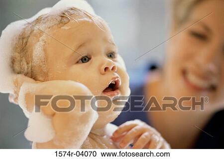 Close-up of a baby boy getting a bath from his mother View Large Photo Image Stock Image - Close-up of a baby boy getting a bath from his mother. Fotosearch