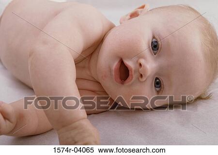 Close-up of a baby boy lying on his side View Large Photo Image Stock Photography - Close-up of a baby boy lying on his side. Fotosearch