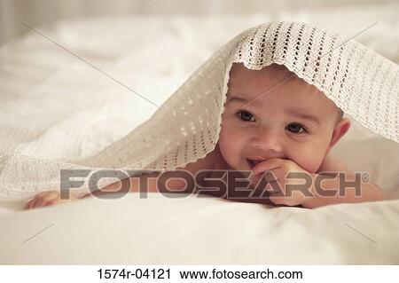 Close-up of a baby boy under a blanket View Large Photo Image Stock Image - Close-up of a baby boy under a blanket. Fotosearch