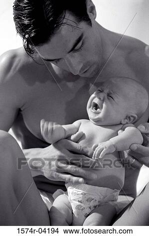 Close-up of a father holding his baby boy View Large Photo Image Picture - Close-up of a father holding his baby boy. Fotosearch