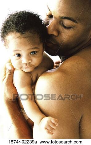 Stock Image - Close-up of a father holding his baby boy. Fotosearch
