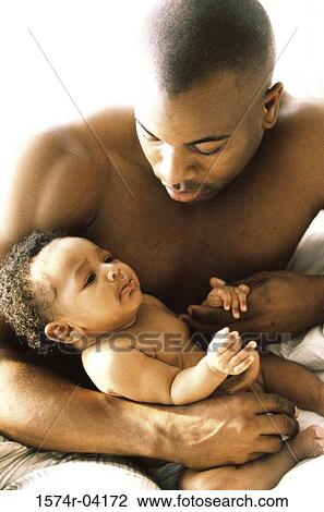 Stock Image - Close-up of a father holding his baby boy. Fotosearch