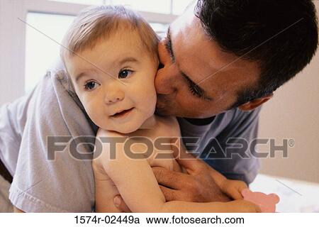 Close-up of a father kissing his baby boy View Large Photo Image Stock Image - Close-up of a father kissing his baby boy. Fotosearch