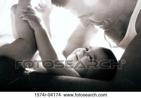 Picture - Close-up of a father playing with his baby boy. Fotosearch