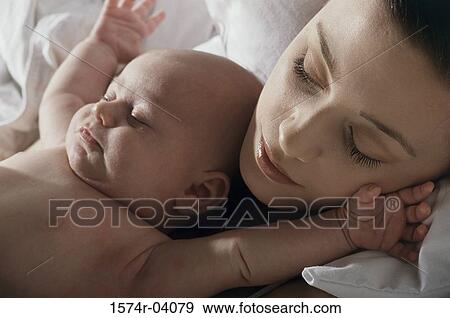Stock Photo - Close-up of a mother and her baby boy sleeping. Fotosearch
