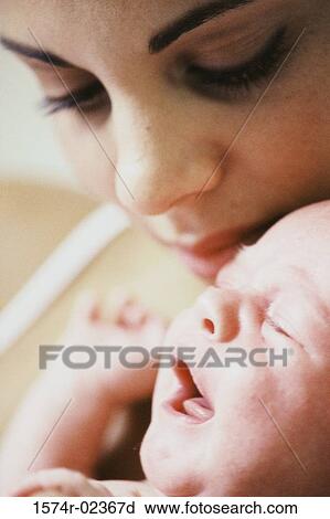 Close-up of a mother carrying her baby boy View Large Photo Image Stock Image - Close-up of a mother carrying her baby boy. Fotosearch