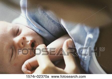 Close-up of a mother holding her baby boy View Large Photo Image Stock Image - Close-up of a mother holding her baby boy. Fotosearch
