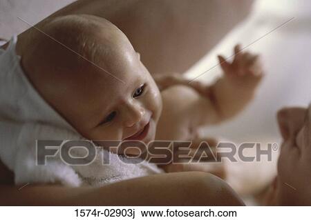 Close-up of a mother holding her baby boy View Large Photo Image Stock Image - Close-up of a mother holding her baby boy. Fotosearch
