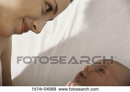 Close-up of a mother holding her baby boy View Large Photo Image Stock Photo - Close-up of a mother holding her baby boy. Fotosearch