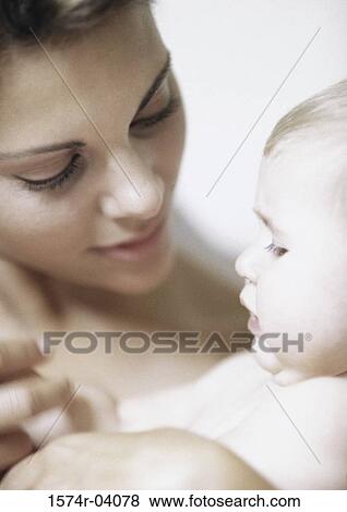 Close-up of a mother holding her baby boy View Large Photo Image Stock Photo - Close-up of a mother holding her baby boy. Fotosearch