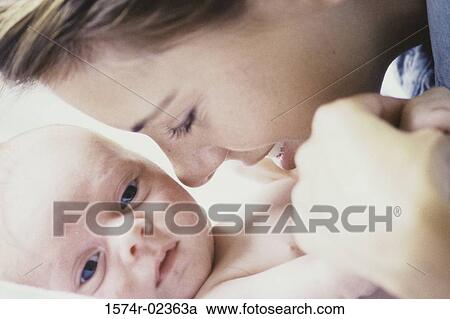 Stock Image - Close-up of a mother playing with her baby boy. Fotosearch
