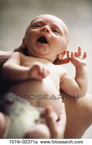 Close-up of a person holding a baby boy View Large Photo Image Stock Image - Close-up of a person holding a baby boy. Fotosearch