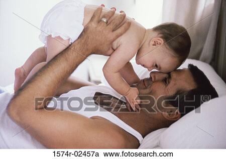 Stock Image - Father holding his baby boy. Fotosearch