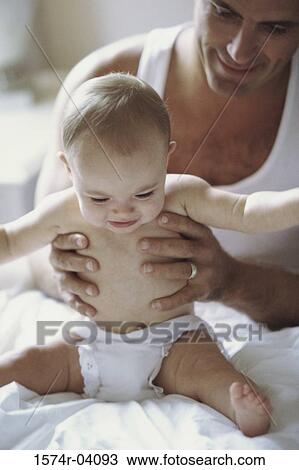 Stock Image - Father holding his baby boy. Fotosearch