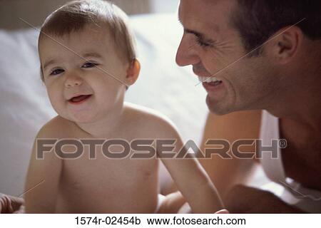 Father looking at his baby boy View Large Photo Image Stock Image - Father looking at his baby boy. Fotosearch