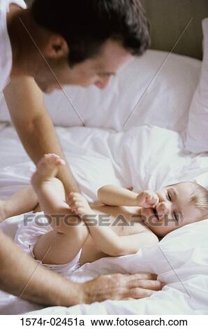 Stock Image - Father playing with his baby boy. Fotosearch