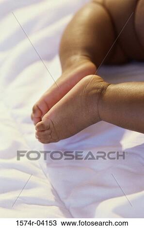 Stock Image - Low section view of a baby's feet. Fotosearch