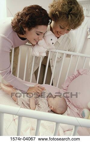 Mother and grandmother playing with a baby girl View Large Photo Image Stock Photo - Mother and grandmother playing with a baby girl. Fotosearch