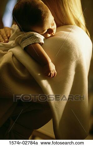 Mother holding her sleeping baby boy View Large Photo Image Stock Image - Mother holding her sleeping baby boy. Fotosearch