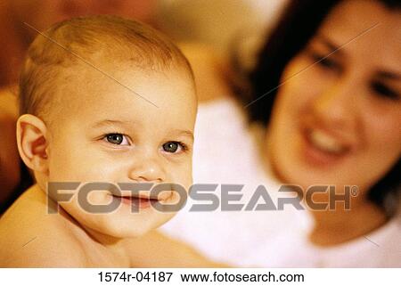 Stock Photo - Mother looking at her baby girl smiling. Fotosearch