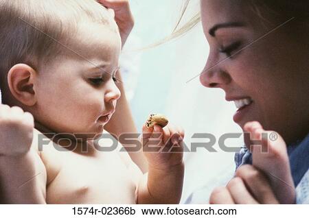 Mother playing with her baby boy View Large Photo Image Stock Image - Mother playing with her baby boy. Fotosearch