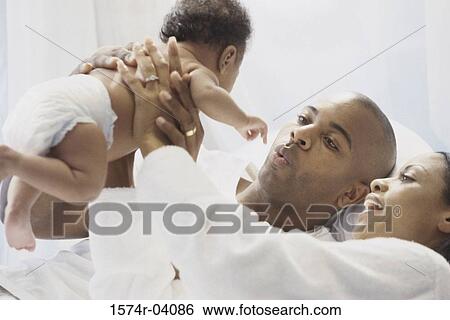 Parents holding their baby boy View Large Photo Image Stock Photograph - Parents holding their baby boy. Fotosearch