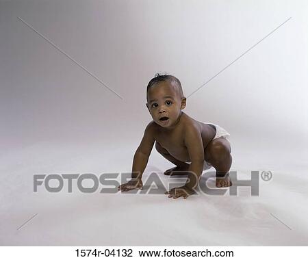 Stock Image - Portrait of a baby boy crawling. Fotosearch